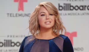 Chiquis Rivera shows off her attributes by modeling a tight white jumpsuit