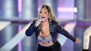 Chiquis Rivera shows off her curves in a high-cut swimsuit while resting on a lounger